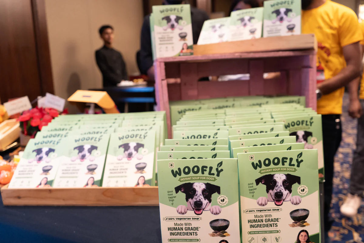 Woofly Instant Soup for Dogs packs on display at a brand event